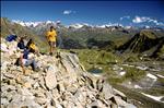 Hikers sitting on Munt Baselgia (2682 m) at the Swiss National Park, Zernez